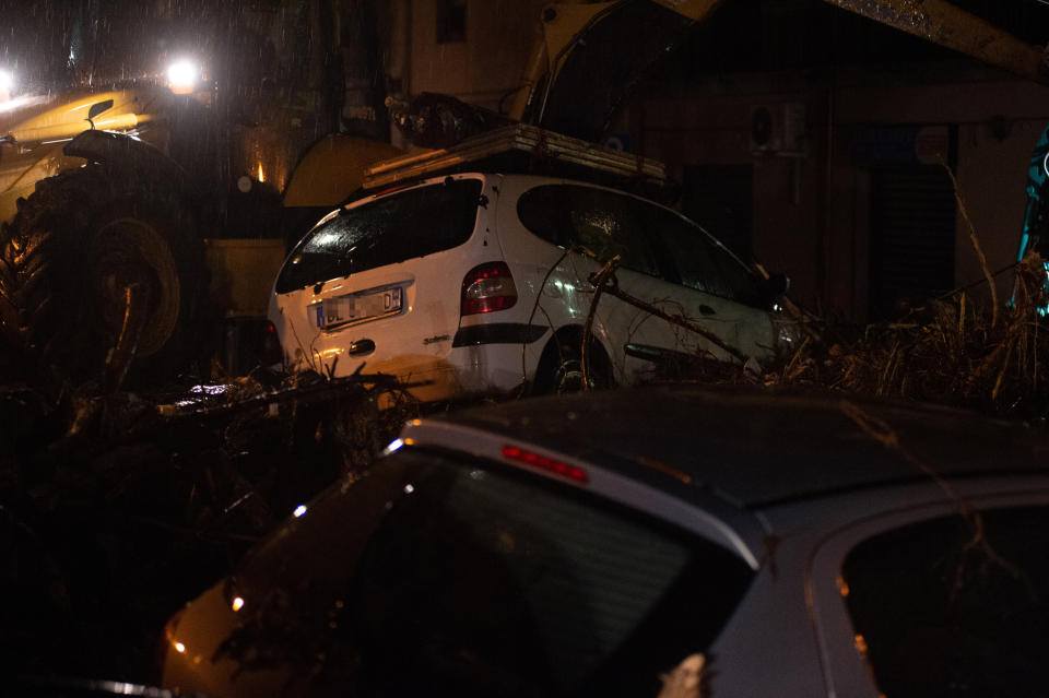 Cars were left among other debris in Bitti, Sardinia, Italy, Saturday, Nov. 28, 2020. The town of Bitti in Sardinia was hit by a storm and flooded by a massive mudslide that killed at least 2 people on Saturday. (Alessandro Tocco/LaPresse via AP)