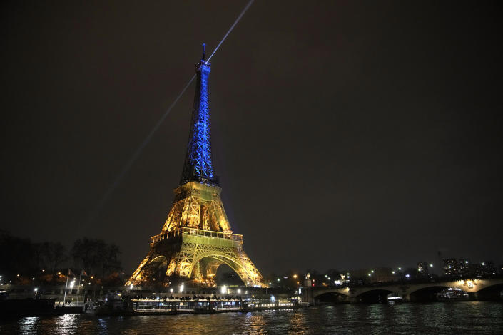 The Eiffel Tower is illuminated with the colors of Ukraine to mark the one-year anniversary of Russia's invasion of the country, in Paris, Thursday, Jan. 23, 2023. (AP Photo/Christophe Ena)