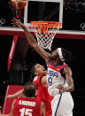 United States' Jerami Grant (9), right, blocks a shot by Iran's Mohammadsina Vahedi (3), center, during men's basketball preliminary round game at the 2020 Summer Olympics, Wednesday, July 28, 2021, in Saitama, Japan. (AP Photo/Charlie Neibergall)