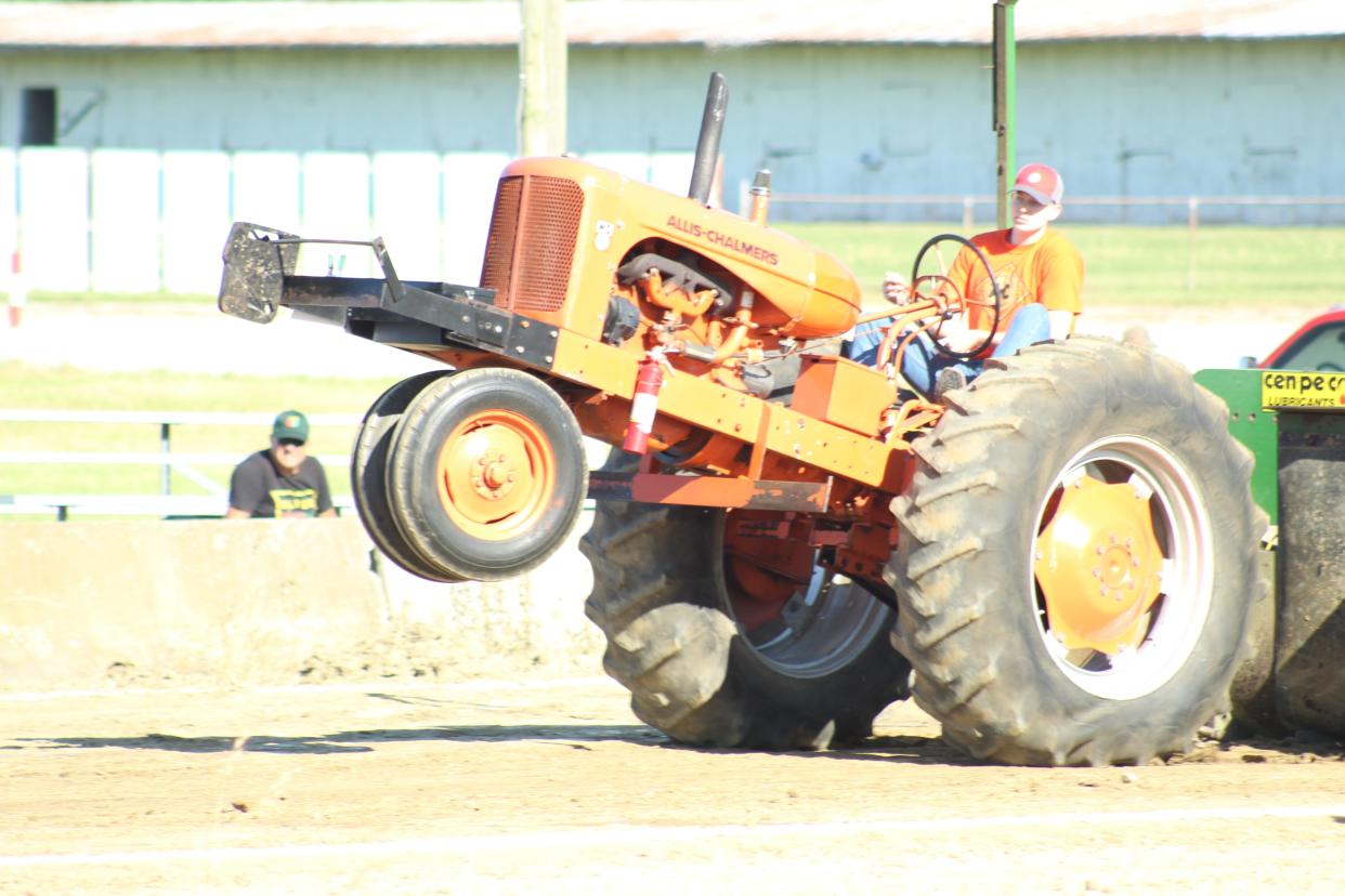 Brandon Seasly drives a 1942 Allis-Chalmers tractor at the antique tractor show at the Crawford County Fairgrounds Friday evening.