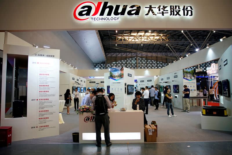 FILE PHOTO: People visit a Dahua Technology booth at a security exhibition in Shangha
