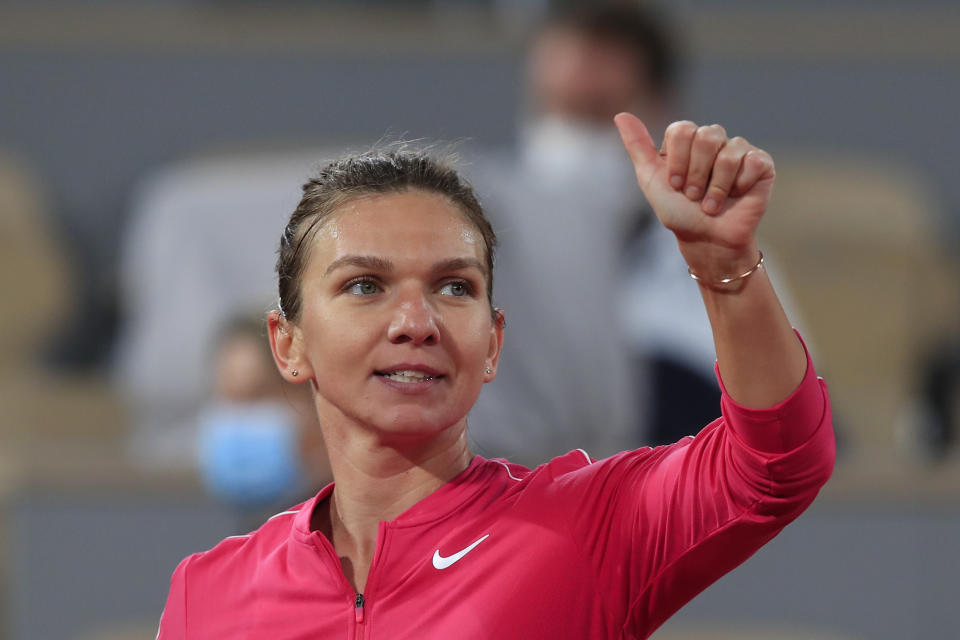 Romania's Simona Halep flashes a thumbs up after winning her third round match of the French Open tennis tournament against Amanda Anisimova of the U.S. in two sets, 6-0, 6-1, at the Roland Garros stadium in Paris, France, Friday, Oct. 2, 2020. (AP Photo/Michel Euler)