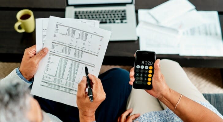 A couple calculates their required minimum distributions (RMDs). The IRS has updated its Uniform Lifetime Table, lowering the size of RMDs in 2022. 