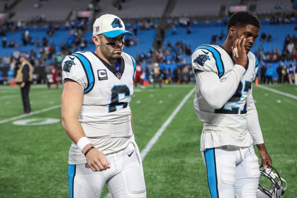 Panthers quarterback Baker Mayfield, left, and teammate, Marquis Blair, walk off the field after losing to the Cardinals, 26-16 on Sunday, October 2, 2022, 2022 in Charlotte, NC.