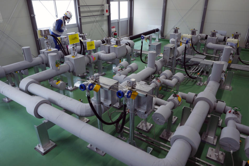 Tomohiko Mayuzumi, a spokesperson of Tokyo Electric Power Company Holdings, or TEPCO, looks at an emergency shutdown system, as part of the facility for the release of treated radioactive water to sea from the Fukushima Daiichi nuclear power plant during a tour for The Associated Press, in Futaba town, northeastern Japan, Friday, July 14, 2023. (AP Photo/Hiro Komae)