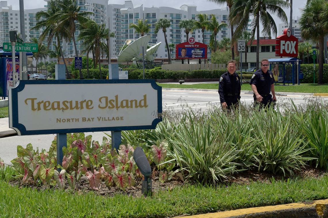 In 2010, then-newly appointed Police Chief Robert Daniels and Lt. James McVay, right, walk by the sign for the Treasure Island neighborhood as they talk about the new traffic cameras proposed in North Bay Village.