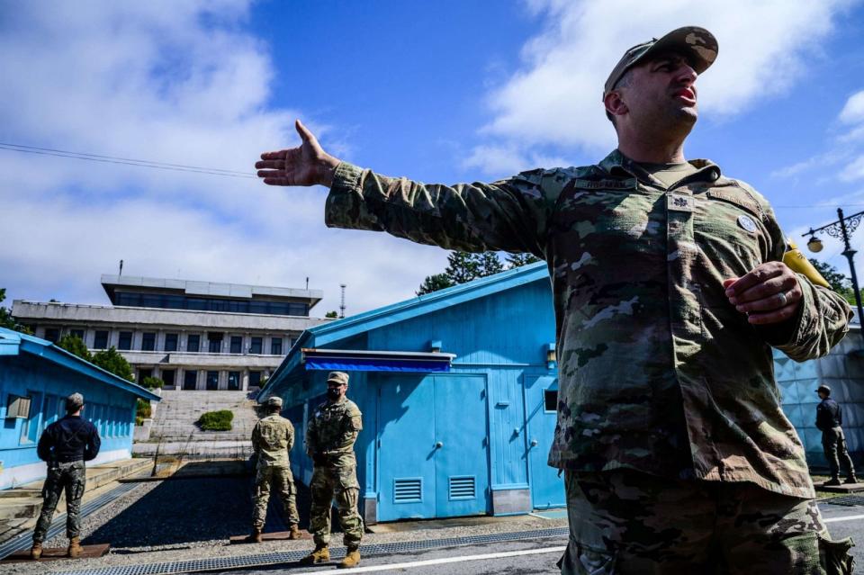 PHOTO: A United Nations Command soldier provides a media tour as a South Korean soldier and others stand guard before the military demarcation line separating North and South Korea, at the Joint Security Area in Panmunjom on October 4, 2022. (Anthony Wallace/AFP via Getty Images)