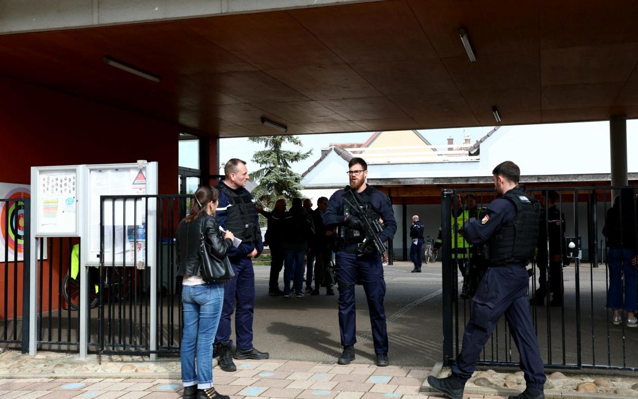 The knifeman, who launched his assault outside the school at about 2pm on Thursday, targeting two girls aged 11 and 7 before fleeing the scene