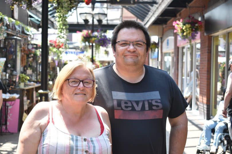 Peter and his mum. Peter's mum is wearing a multicoloured striped shirt and Peter is wearing a Levi's t-shirt