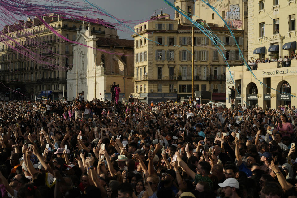 Crowds gather as the Belem, the three-masted sailing ship bringing the Olympic flame from Greece, enters the Old Port in Marseille, southern France, Wednesday, May 8, 2024. The torch was lit in Greece last month before it was officially handed to France. The Paris 2024 Olympic Games will run from July 26 to Aug.11, 2024. (AP Photo/Thibault Camus)