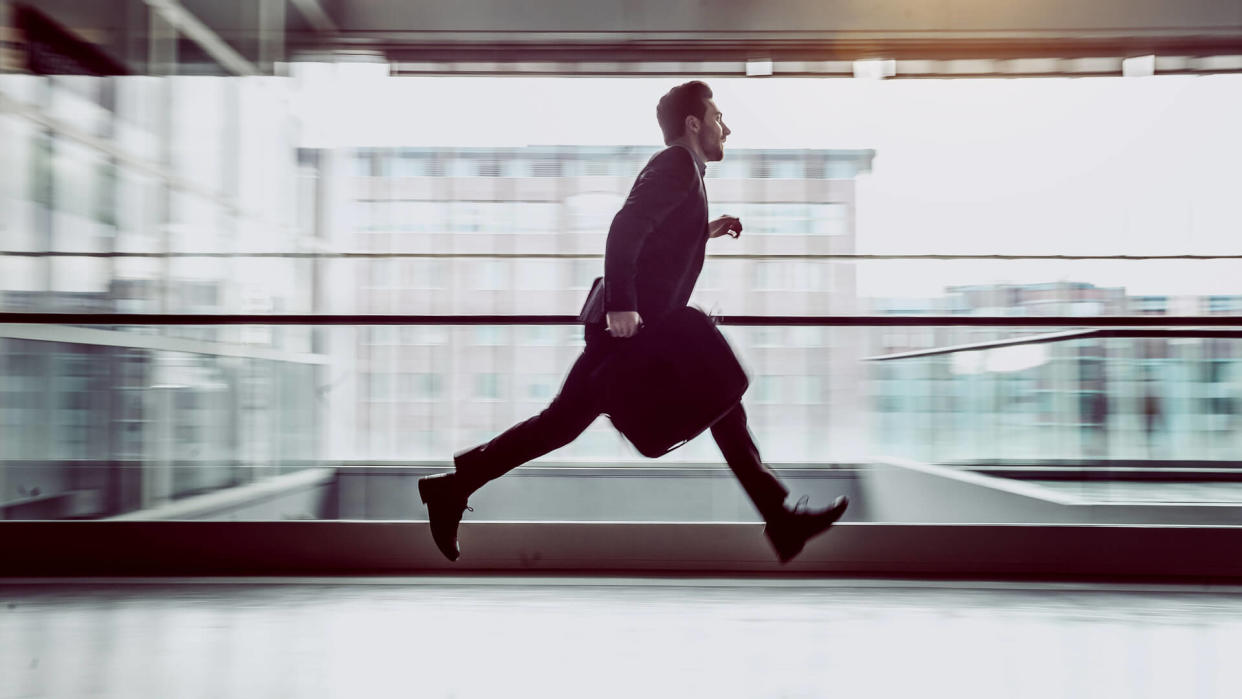 Businessman Running Across The Corridor.