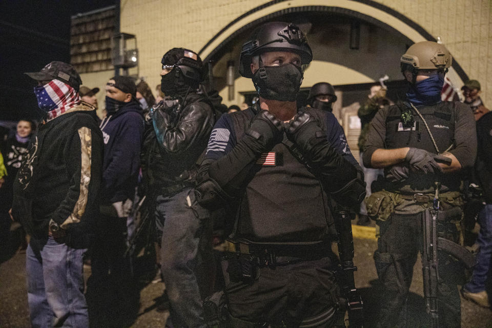 People gather during a counter protest against Black Lives Matter in Vancouver, Wash., Friday, Oct. 30, 2020, after a candlelight vigil for Kevin Peterson Jr., who was killed in Thursday's shooting with police involved. The Clark County Sheriff's office has not released any details on the Thursday evening shooting in Hazel Dell, but a man told The Oregonian/OregonLive that his 21-year-old son was fatally shot by police. (AP Photo/Paula Bronstein)