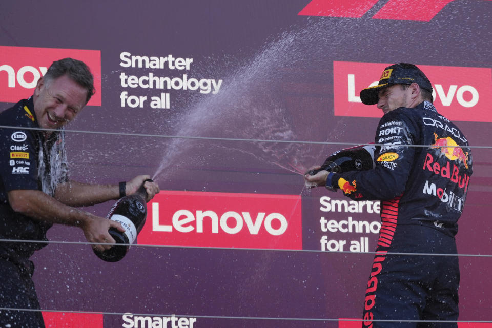 Red Bull team principal Christian Horner, left, celebrates on the podium with Red Bull driver Max Verstappen of the Netherlands after the Japanese Formula One Grand Prix at the Suzuka Circuit, Suzuka, central Japan, Sunday, Sept. 24, 2023. Red Bull won constructors title. (AP Photo/Toru Hanai)