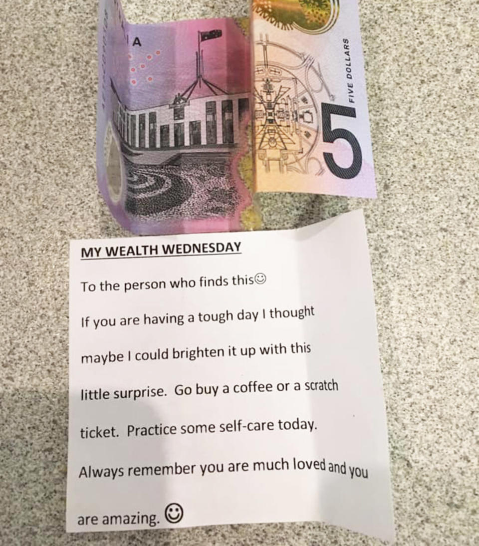 Pictured id a $5 note and kind message left in a random Woolworths box of nappies a Brisbane mum found.