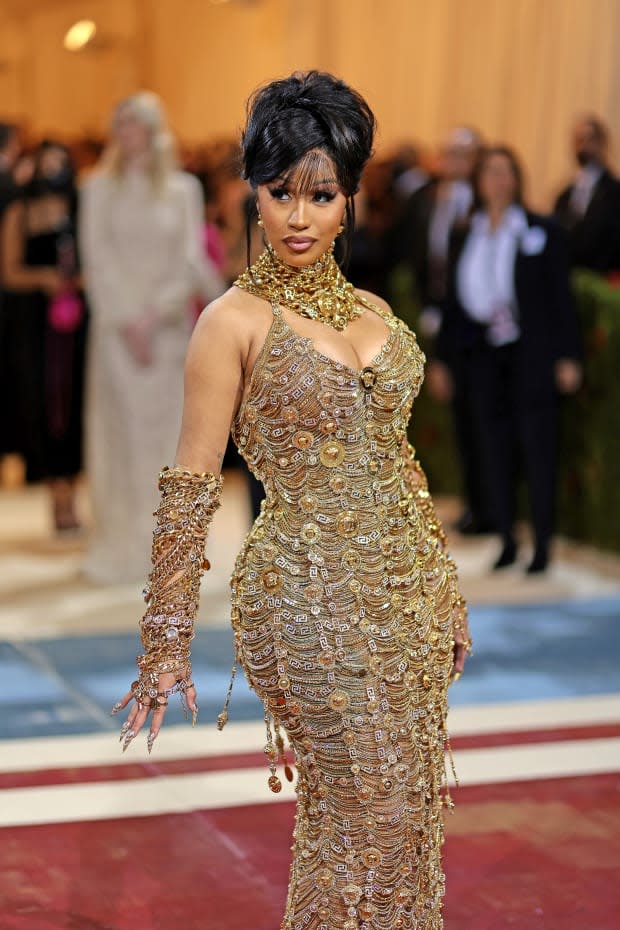 Cardi B in dripping in gold at the 2022 Met Gala, courtesy of Versace.<p>Photo: Dimitrios Kambouris/Getty Images</p>