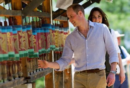 Britain's Prince William, Duke of Cambridge and his wife Catherine, Duchess of Cambridge, spin prayer wheels at the Paro Taktsang Monastery, Bhutan, April 15, 2016. REUTERS/Mark Large/Pool