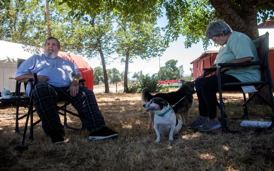 Jeff and Rose Gamble rest in the shade at the evacuation center at the Italian Picnic Grounds in Sutter Creek after fleeing the Electra Fire burning southeast of Jackson, Calif.