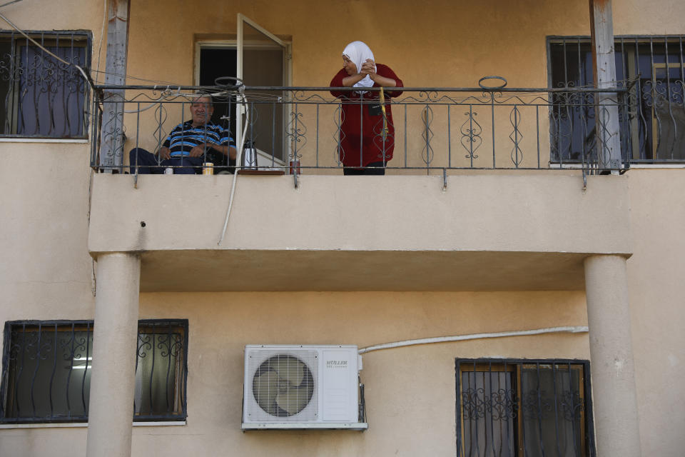 Locals look at Palestinian fugitive Zakaria Zubeidi's hideouts in Umm al-Ghanam, northern Israel, Saturday, Sept. 11, 2021. Following Zubeidi's arrest, police said they have caught four of six Palestinians who broke out of a maximum-security prison early this week. (AP Photo/Ariel Schalit)