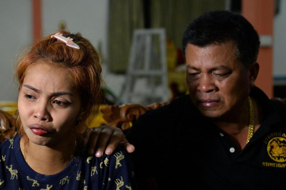 Mother: Jiranuch is comforted her by father at a temple in Phuket (REUTERS)