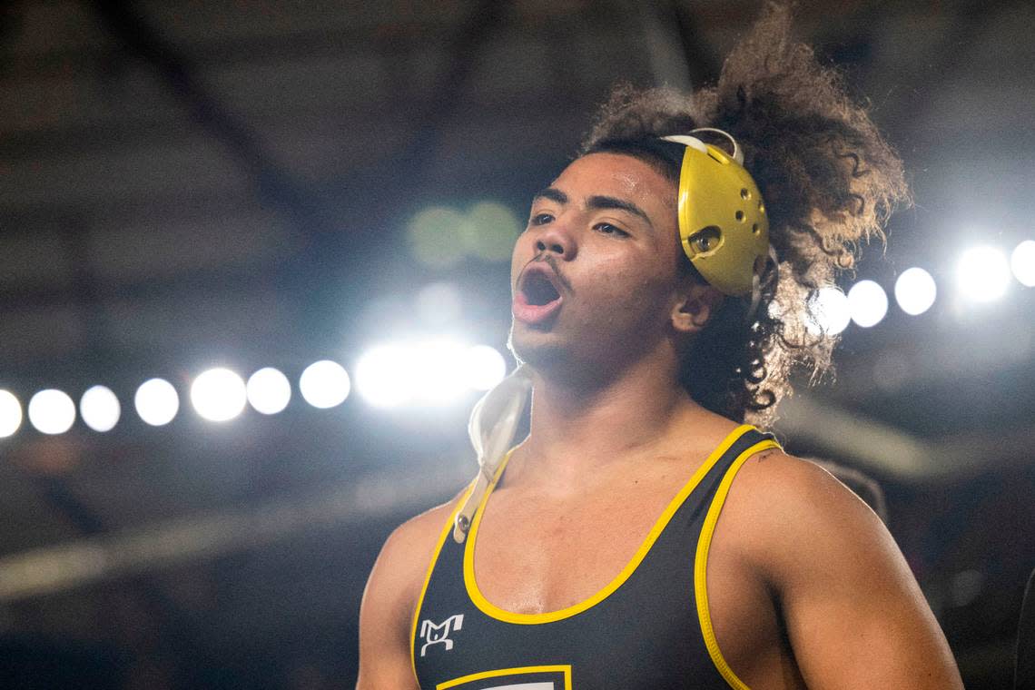 Lincoln’s Navarre Dixon celebrates after pinning Stanwood’s Mason Ferguson in a 182-pound, Class 3A semifinal match at Mat Classic XXXIV on Saturday, Feb. 18, 2023, at the Tacoma Dome in Tacoma, Wash.