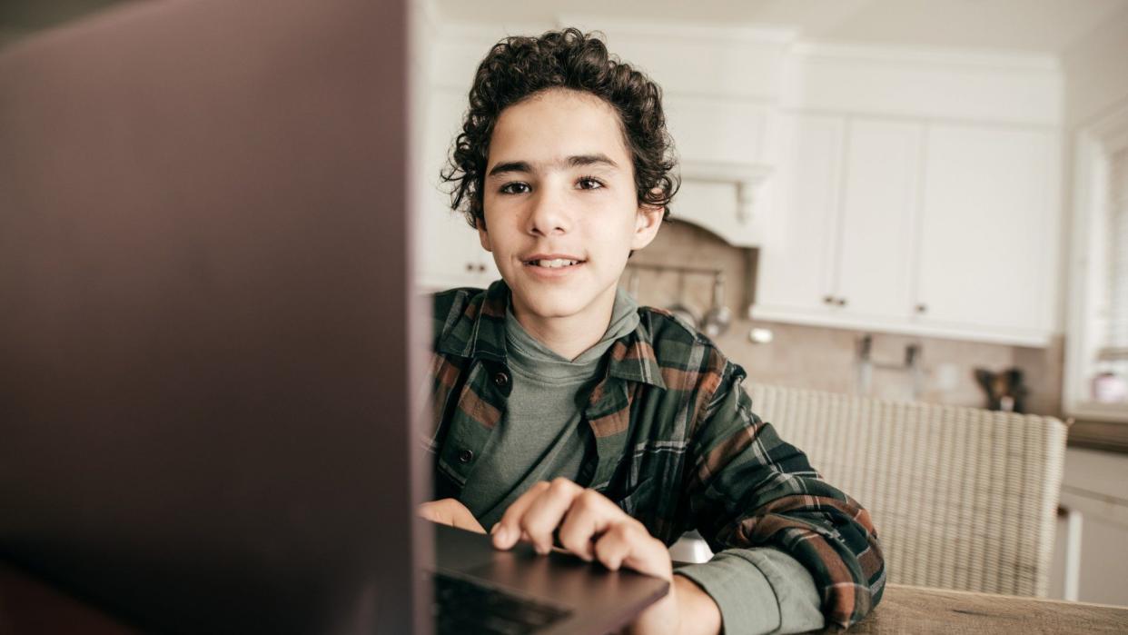 Teens in domestic kitchen.