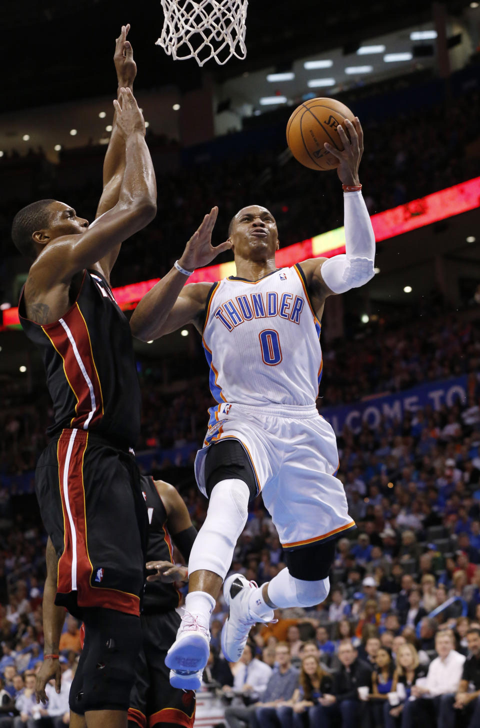 Oklahoma City Thunder guard Russell Westbrook (0) shoots in front of Miami Heat center Chris Bosh (1) during the third quarter of an NBA basketball game in Oklahoma City, Thursday, Feb. 20, 2014. Miami won 103-81. (AP Photo/Sue Ogrocki)