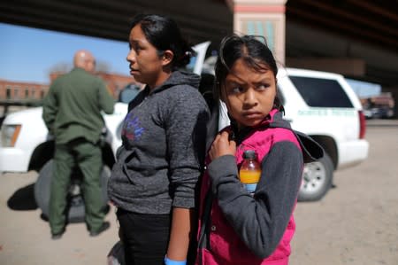 FILE PHOTO: Guatemalan migrants Ismelda Cipriano, 31, and her daughter Petronila Cipriano, 12, wait to be processed after surrendering to U.S. Border Patrol Agents in El Paso