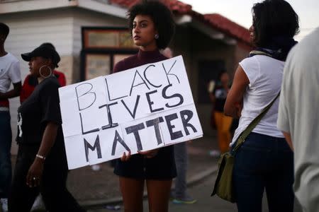 Protesters gather along Broadway Avenue to protest the fatal shooting of an unarmed black man on Tuesday by officers in El Cajon, California, U.S. September 28, 2016. REUTERS/Sandy Huffaker