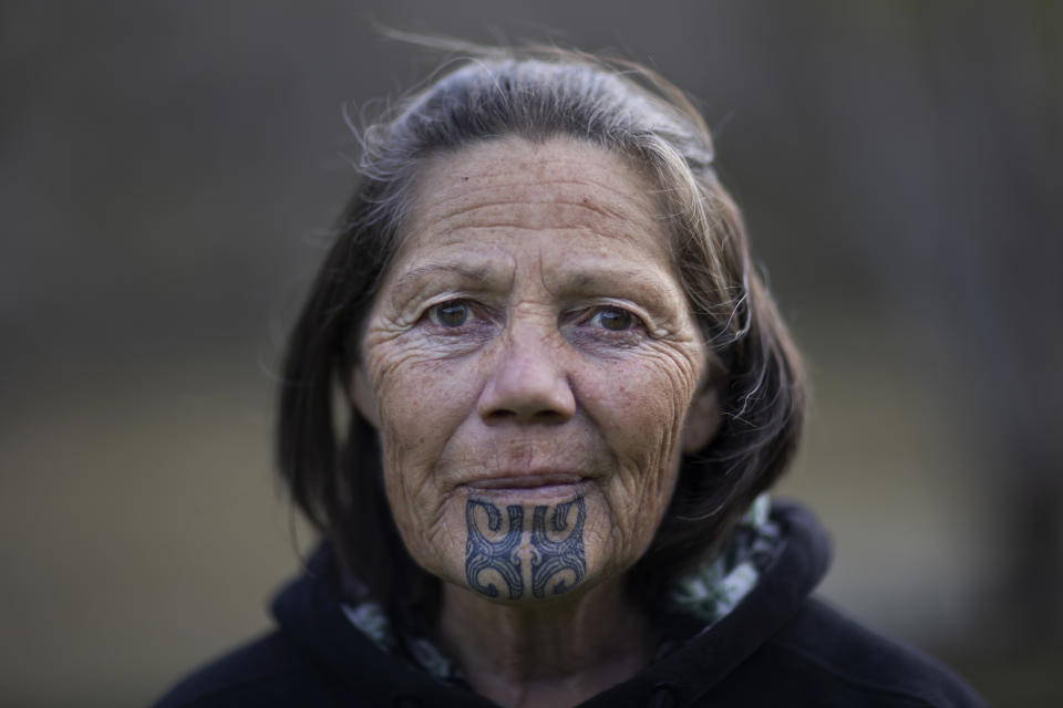Frances Marshall stands for a portrait near the town of Whakaihuwhaka, New Zealand, where she runs the Rivertime Lodge on the banks of the Whanganui River, on June 15, 2022. The moko kauae tattoo on her chin represents a woman's family, status and leadership within her community. (AP Photo/Brett Phibbs)