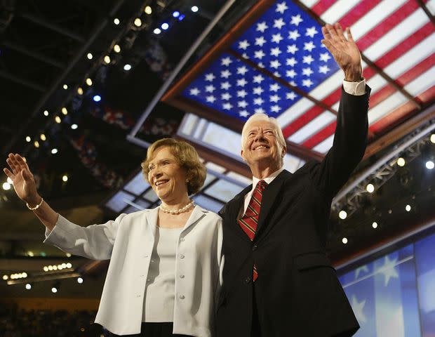 Scott Olson/Getty Rosalynn and Jimmy Carter wave to the audience at the 2004 Democratic National Convention