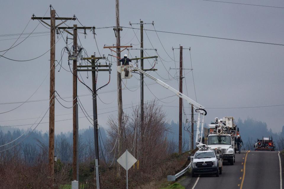 Crews work to restore power along Dale Kuni Road as winter storm recovery continues Friday, Jan. 19, 2024, near Creswell, Ore.