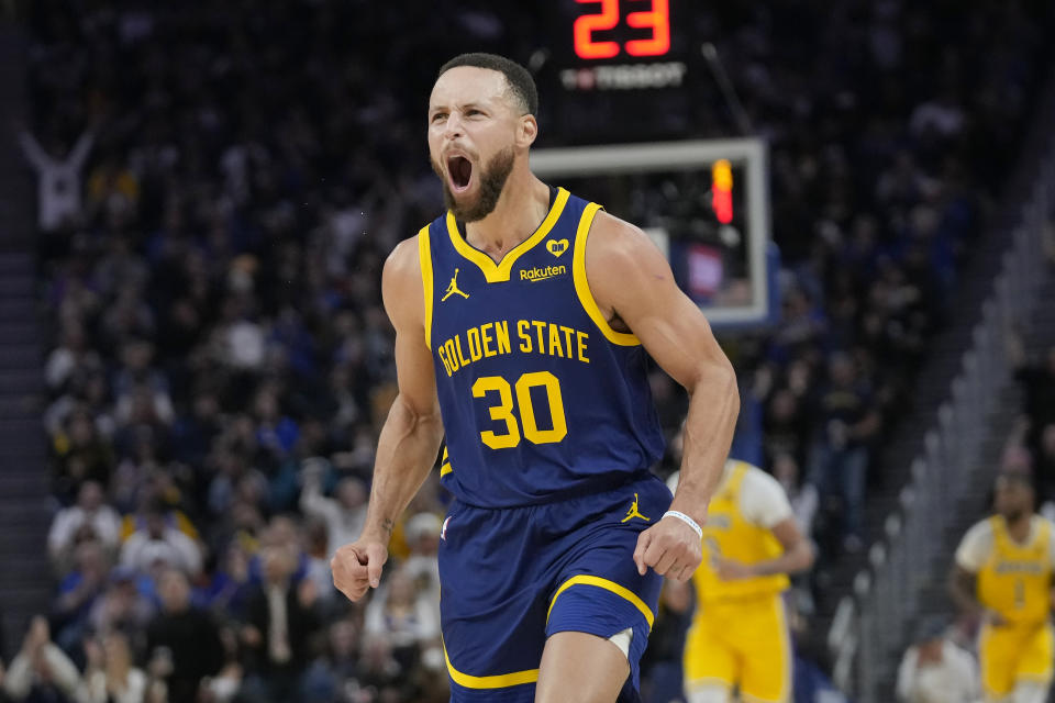 Golden State Warriors guard Stephen Curry (30) reacts after making a 3-point basket against the Los Angeles Lakers during the first half of an NBA basketball game in San Francisco, Thursday, Feb. 22, 2024. (AP Photo/Jeff Chiu)