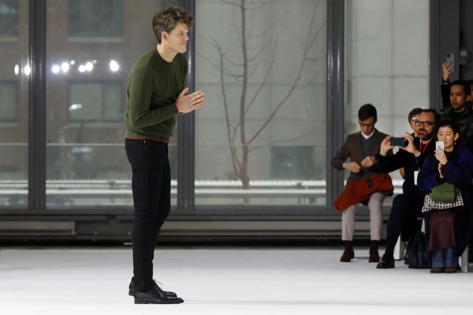 Creative Director Wes Gordon, for Carolina Herrera, acknowledges audience applause after his collection was modeled during Fashion Week, in New York, Monday, Feb. 10, 2020. (AP Photo/Richard Drew)