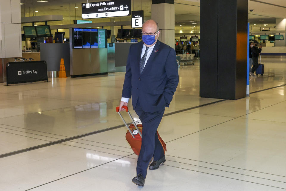 France's Ambassador to Australia Jean-Pierre Thebault arrives at Sydney Airport, Saturday, Sept. 18, 2021. Thebault has described as a "huge mistake" Australia's surprise cancellation of a major submarine contract in favor of a U.S. deal, in an unprecedented show of anger among the allies. (AP Photo/David Gray)