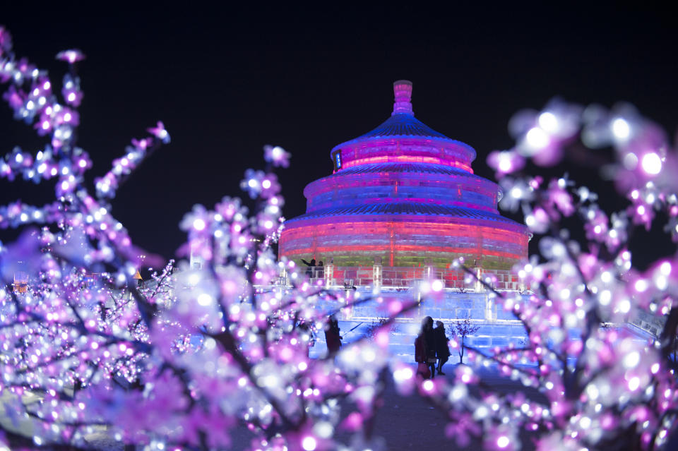 <p>Tourists visit illuminated ice sculptures at Ice and Snow World park on Jan. 4 in Harbin, China. (Photo: Tao Zhang/Getty Images) </p>