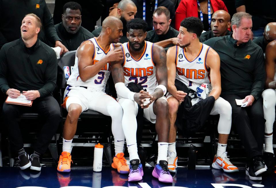 Apr 29, 2023; Denver, CO, USA; Phoenix Suns guard Chris Paul (3) talks to center Deandre Ayton (22), and guard Devin Booker (1) after leaving the game against the Denver Nuggets in the fourth quarter during Game 1 of the Western Conference Semifinals at Ball Arena. Mandatory Credit: Rob Schumacher-Arizona Republic