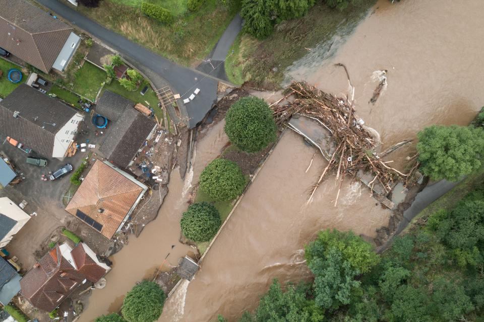 TOPSHOT - An aerial view taken on July 15, 2021 shows a bridge damaged by trunks following heavy rains and flood in Echtershausen, near Bitburg, western Germany. - Heavy rains and floods lashing western Europe have killed at least 59 people in Germany and eight in Belgium, and many more people are missing as rising waters caused several houses to collapse on July 15, 2021. (Photo by SEBASTIEN BOZON / AFP) (Photo by SEBASTIEN BOZON/AFP via Getty Images)