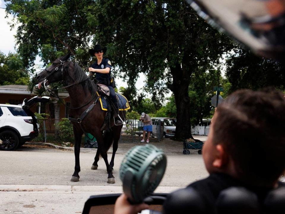 Franco Bernal, 6, battling childhood leukemia, right, waves goodbye to City of Miami Police officer Vanessa Garcia after his Make-A-Wish to go to Disney World was granted on Thursday, July 18, 2024, with a parade by Make-A-Wish and City of Miami Police in Miami.