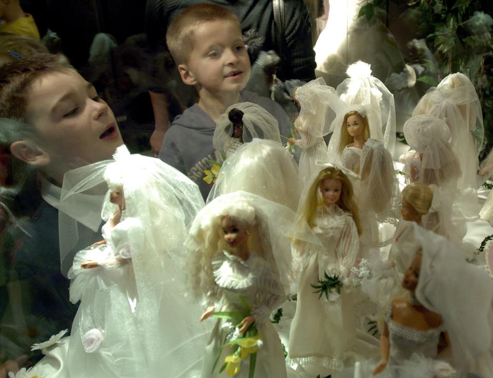 Two young Polish boys look at Barbie dolls in wedding dresses at an exhibition of more tham 100 Barbie and Ken dolls in Warsaw, Poland, Tuesday, Nov. 21, 2006. (AP Photo/Czarek Sokolowski)