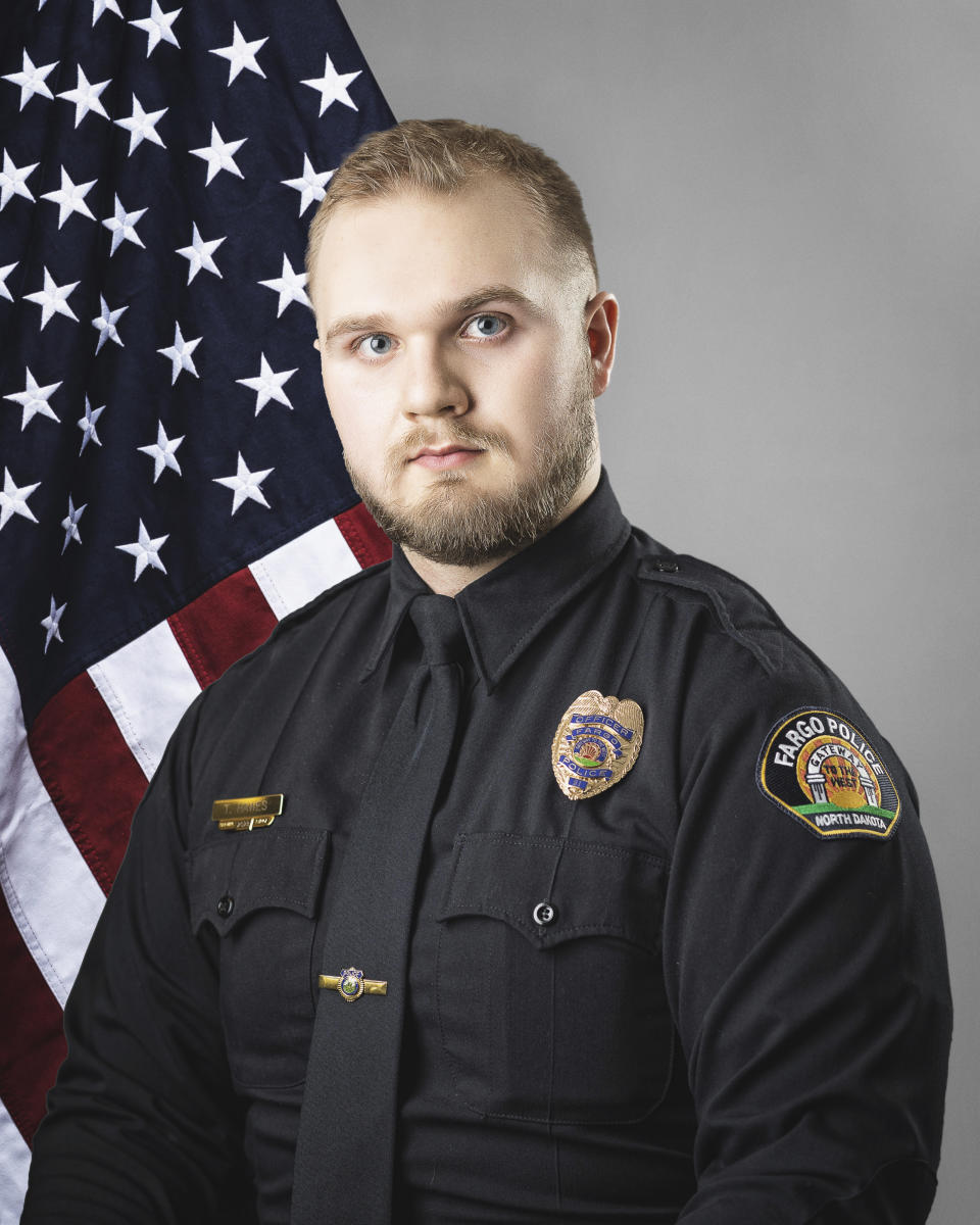 This photo provided by The City of Fargo, N.D., on Saturday, July 15, 2023 shows police officer Tyler Hawes. On Saturday, Fargo's police chief said a gunman opened fire on police and firefighters as they responded to a traffic crash in North Dakota. One officer was killed and Hawes and another were wounded before a fourth officer killed him. (The City of Fargo via AP)