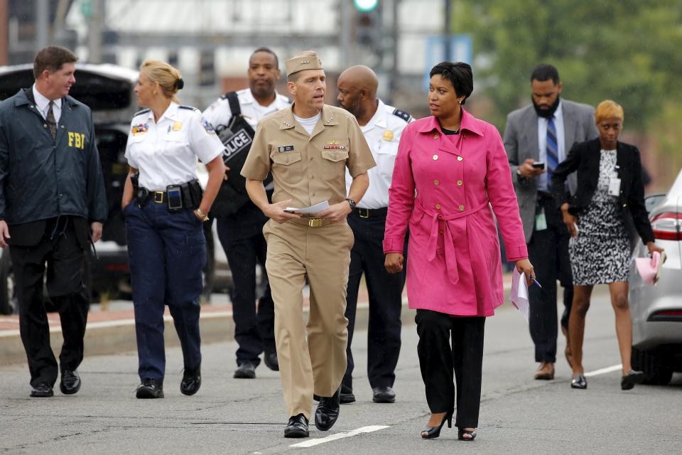 Washington DC Mayor Muriel Bowser (R, in pink coat) and U.S. Navy Vice-Admiral Dixon Smith (center L) arrive to address the media following a lockdown at the U.S. Navy Yard in Washington July 2, 2015. (REUTERS/Jonathan Ernst)