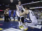 Memphis Grizzlies forward Mike Miller (13) helps Marc Gasol (33) up off the court in the second half of Game 3 of an opening-round NBA basketball playoff series against the Oklahoma City Thunder on Thursday, April 24, 2014, in Memphis, Tenn. The Grizzlies won 98-95 in overtime. (AP Photo/Mark Humphrey)