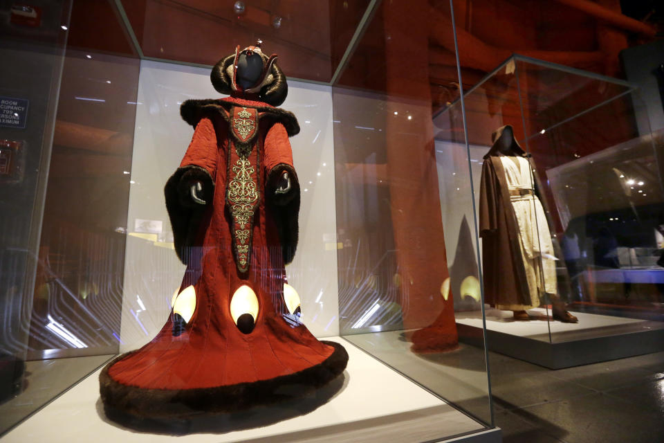 Queen Amidala's throne room gown, left, and Obi-Wan Kenobi's costume. (AP Photo/Elaine Thompson)