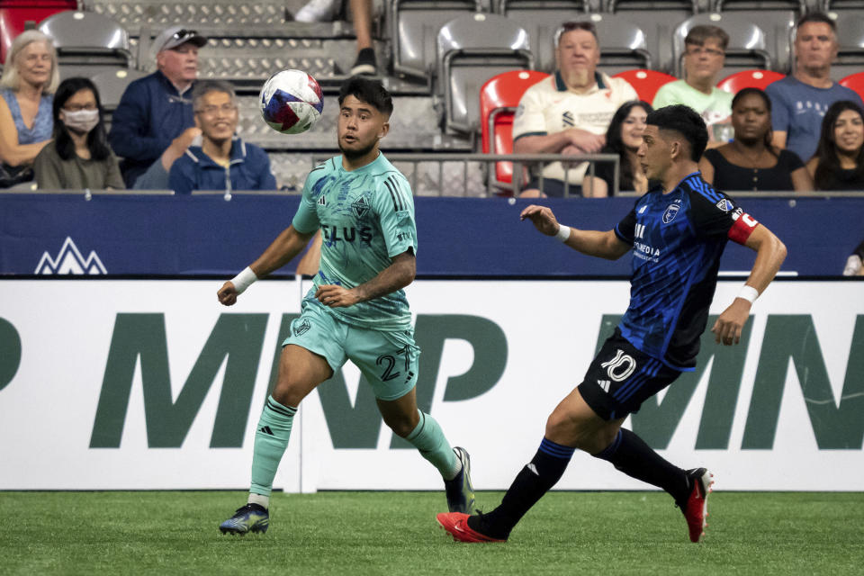 Vancouver Whitecaps' Ryan Raposo (27) tries to gain possession of the ball with pressure from San Jose Earthquakes' Cristian Espinoza (10) during first-half MLS soccer match action in Vancouver, British Columbia, Sunday, Aug. 20, 2023. (Ethan Cairns/The Canadian Press via AP)