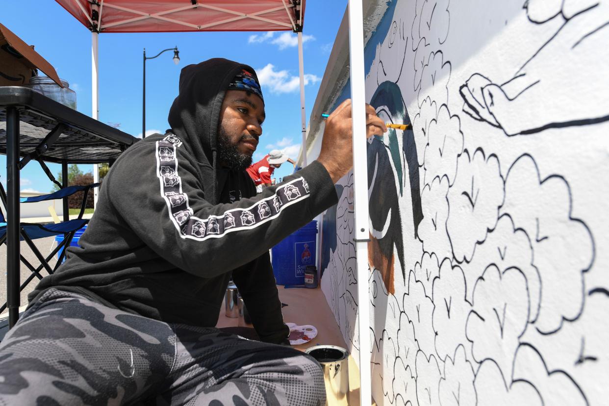 Theron Cartwright, of Augusta, paints a duck for the 5th Street Mural Festival near the intersection of 5th Street and Reynolds Street on Monday, April 22, 2024. Muralists will be painting through the week, with a ribbon cutting to be held on Saturday.