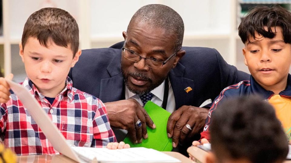 New Wake County Superintendent Robert Taylor speaks with second grade students Felix Moss, left, and Cesar Vera Quinones, right, during a tour of Rolesville Elementary School on his first day on the job on Monday, Oct. 2, 2023, in Rolesville, N.C.