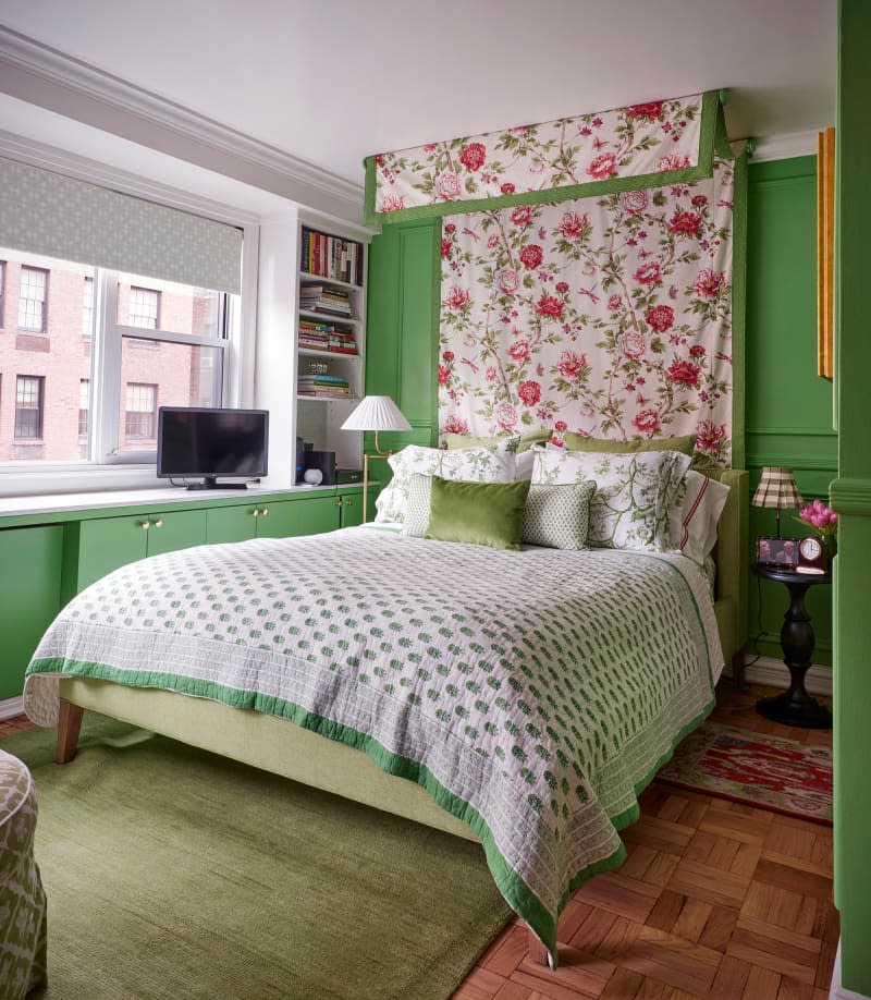 Floral canopy above bed in green bedroom with wide window.