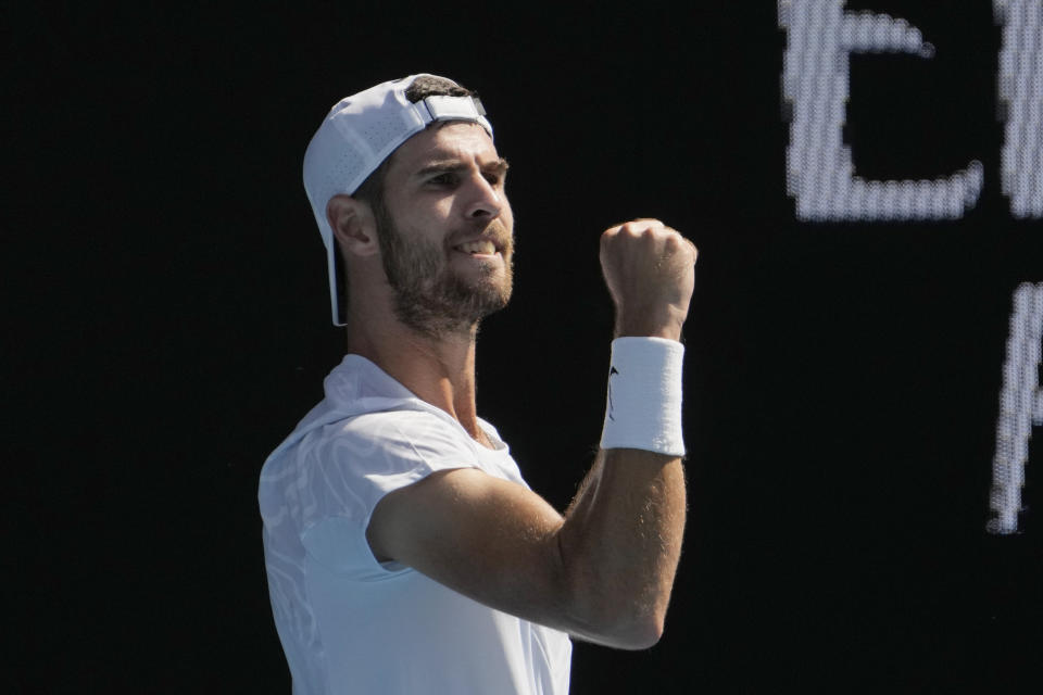 Karen Khachanov of Russia celebrates after defeating Yoshihito Nishioka of Japan during their fourth round match at the Australian Open tennis championship in Melbourne, Australia, Sunday, Jan. 22, 2023. (AP Photo/Ng Han Guan)