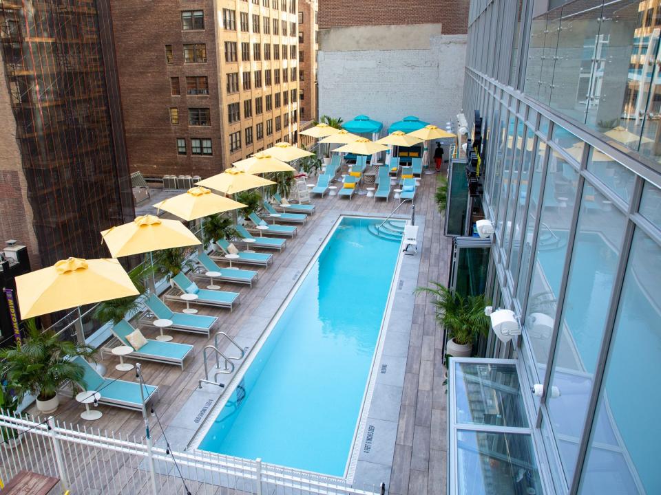 overhead look at the empty pool with yellow umbrellas