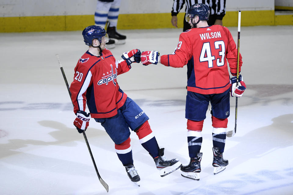 Washington Capitals center Lars Eller (20), of Denmark, celebrates his empty net goal with right wing Tom Wilson (43) during the third period of an NHL hockey game against the Winnipeg Jets, Sunday, March 10, 2019, in Washington. The Capitals won 3-1. (AP Photo/Nick Wass)